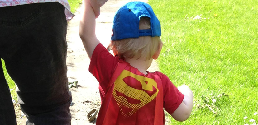 Little boy wearing Superman cape